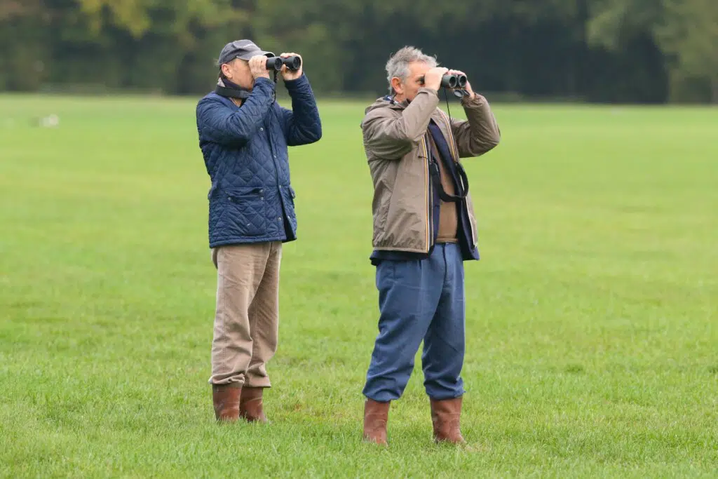 2 hommes qui regardent avec des jumelles